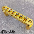 A gold tune-o-matic bridge for 6 string electric guitars like Gibson. It is has high quality and perfect for guitar building.