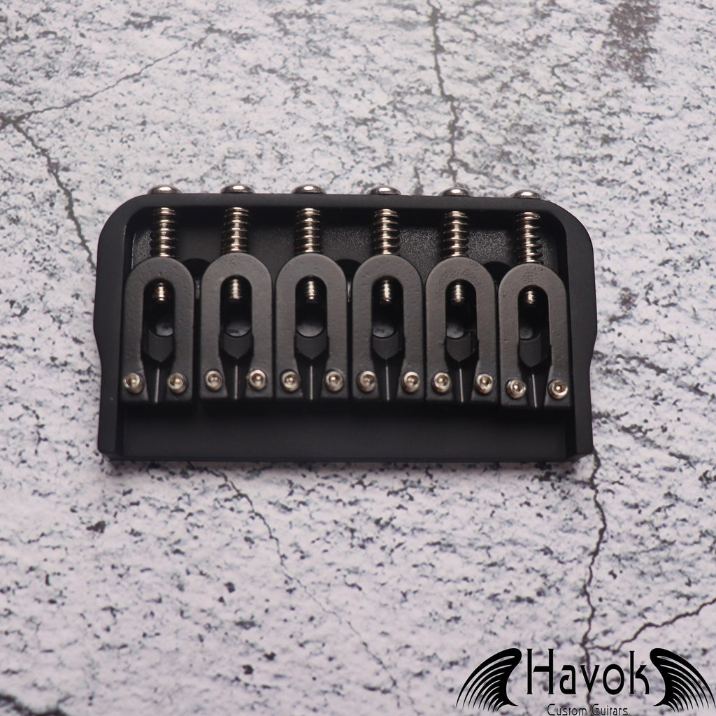 A low profile Hard Tail Bridge in black color. It's made from stainless steel and has very high quality for guitar building.