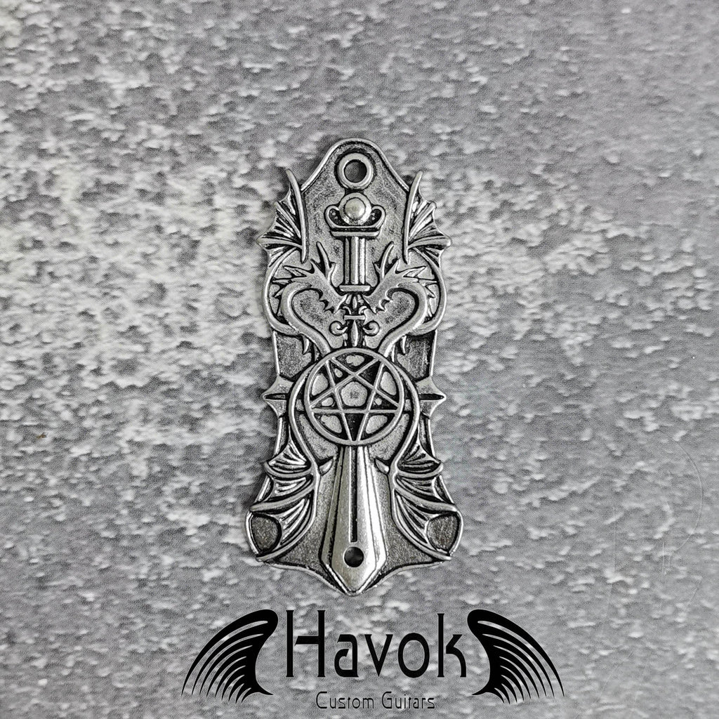 A vintage style metal truss rod plate for electric guitars. It comes in unique design of pentagram and two dragons. The color is silver.