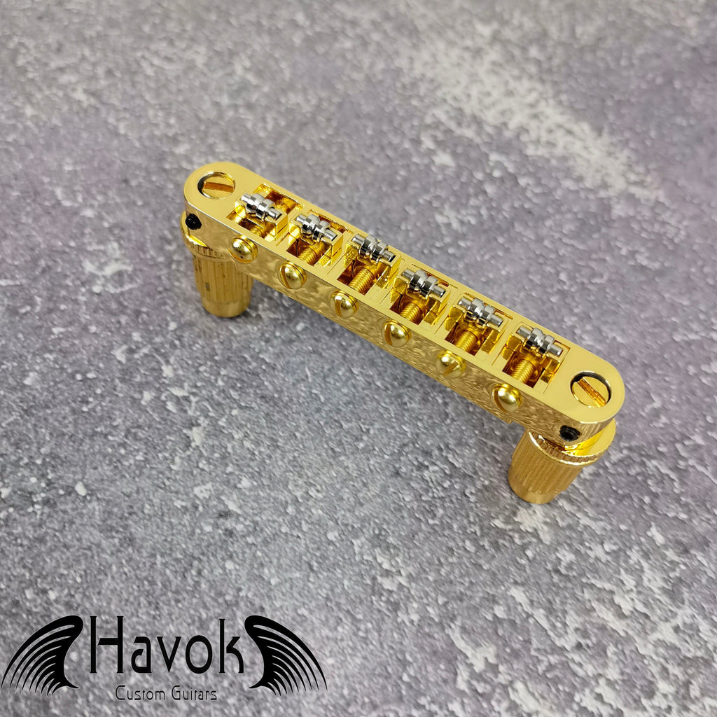 A gold tune-o-matic bridge for 6 string electric guitars like Gibson. It is has high quality and perfect for guitar building.