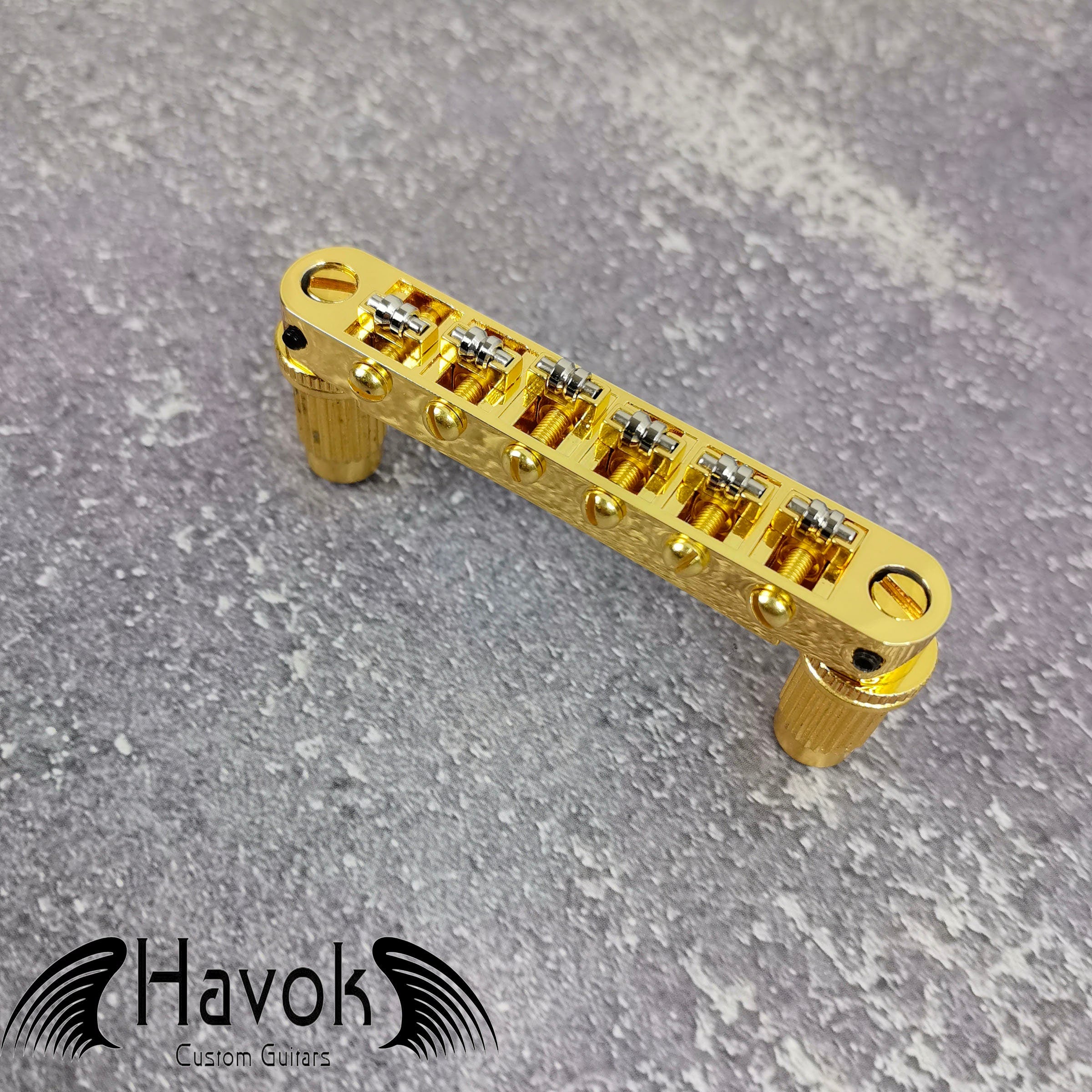 A gold tune-o-matic bridge for 6 string electric guitars like Gibson. It is has high quality and perfect for guitar building.