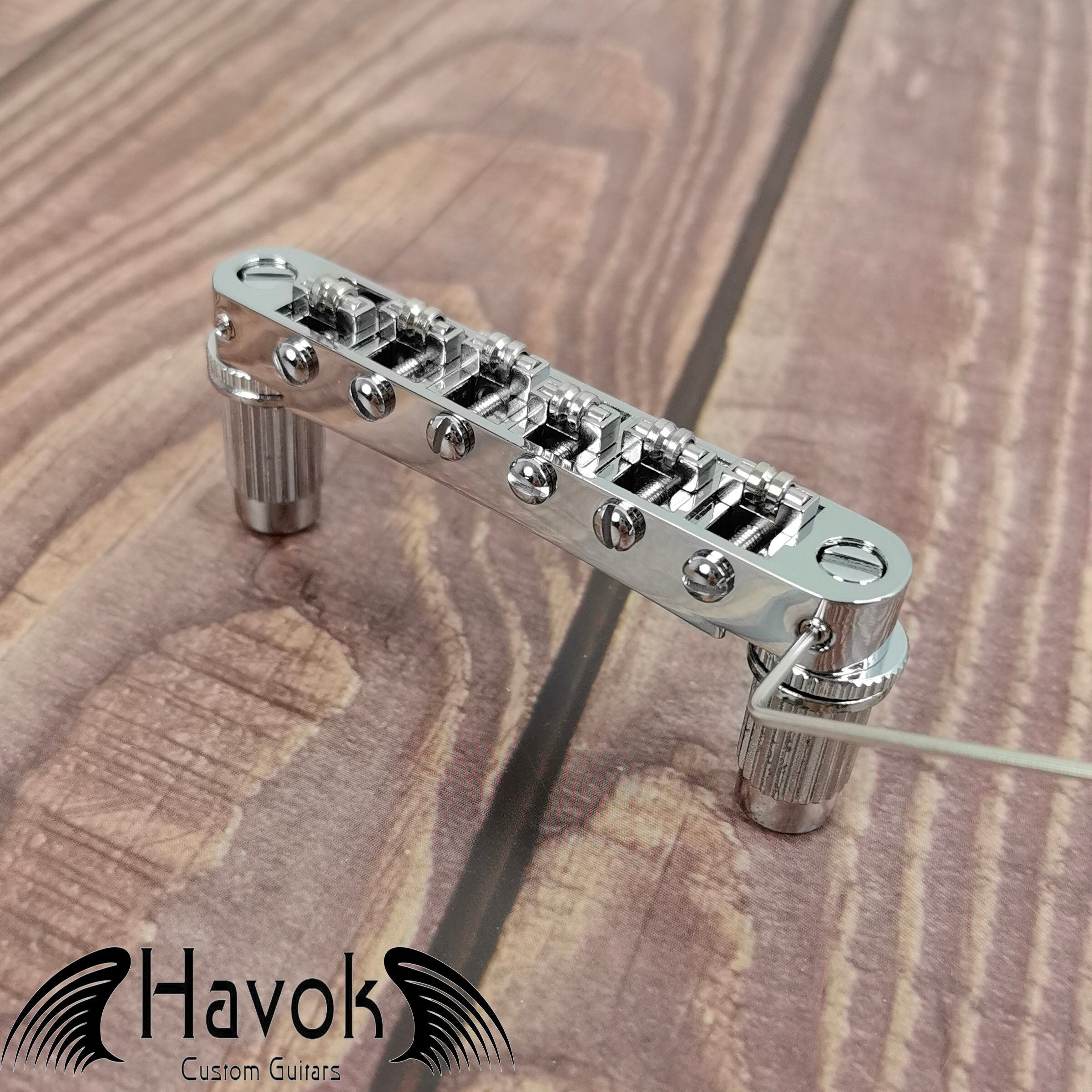 A silver tune-o-matic bridge for 6 string electric guitars like Gibson. It is has high quality and perfect for guitar building.